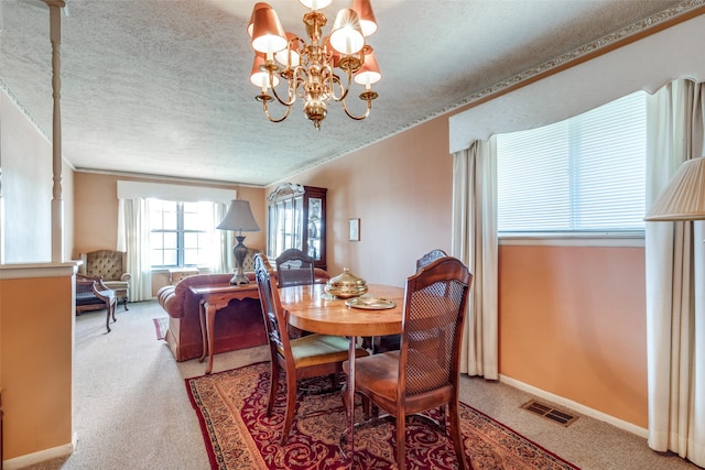 carpeted dining area featuring crown molding, an inviting chandelier, and a textured ceiling