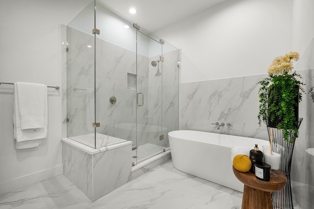 bathroom featuring separate shower and tub