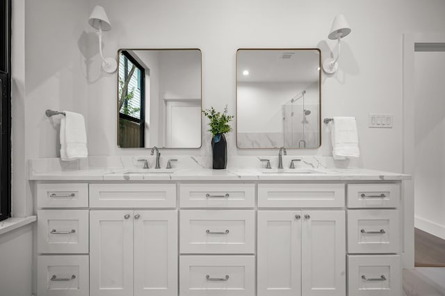 bathroom featuring vanity and a shower with door