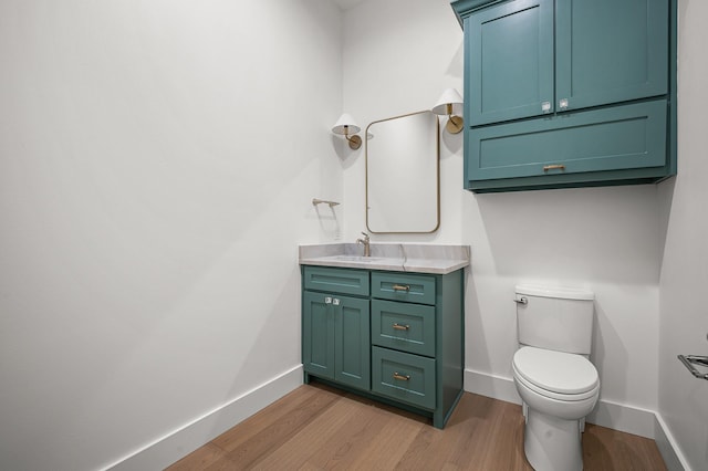 bathroom with vanity, hardwood / wood-style flooring, and toilet