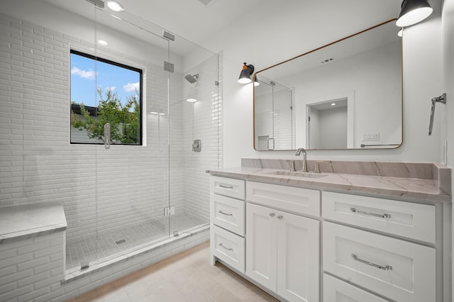 bathroom with vanity, tile patterned floors, and a shower with shower door