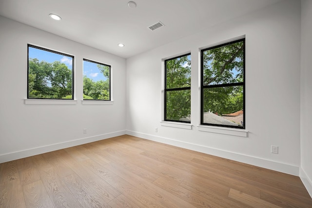 unfurnished room with light hardwood / wood-style floors