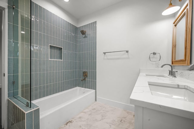 bathroom featuring vanity and tiled shower / bath