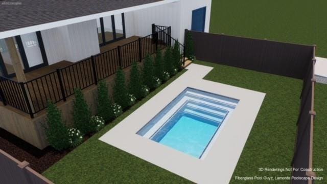 view of swimming pool featuring a lawn