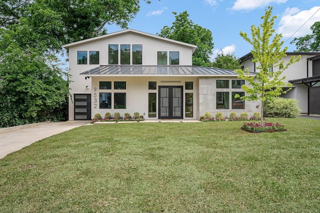 view of front of home with a garage and a front yard