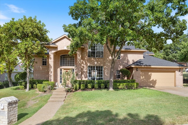 view of front of house featuring a garage and a front lawn