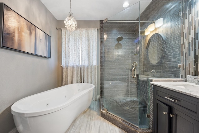 bathroom with vanity and shower with separate bathtub