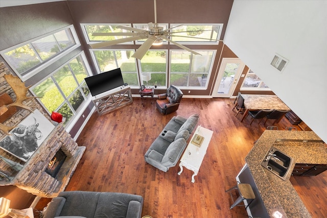 living room with ceiling fan, high vaulted ceiling, and dark hardwood / wood-style flooring