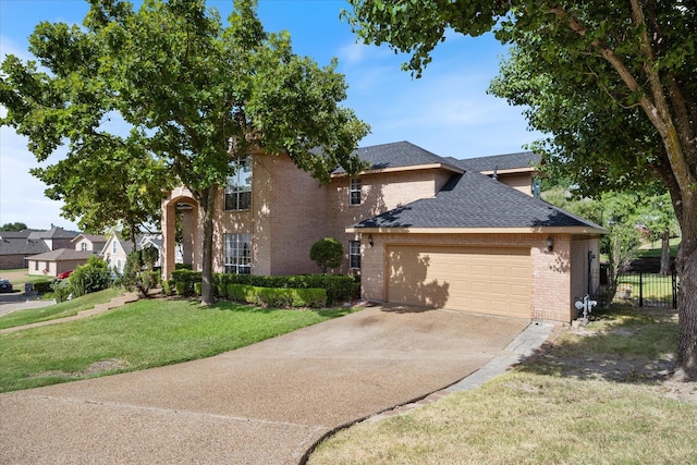 view of front of property featuring a front yard and a garage