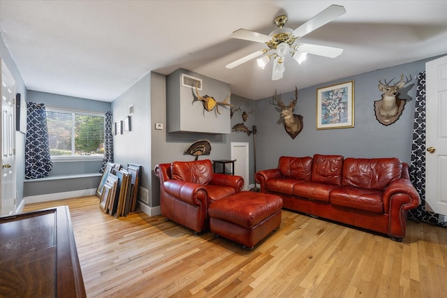 living room featuring light hardwood / wood-style floors and ceiling fan