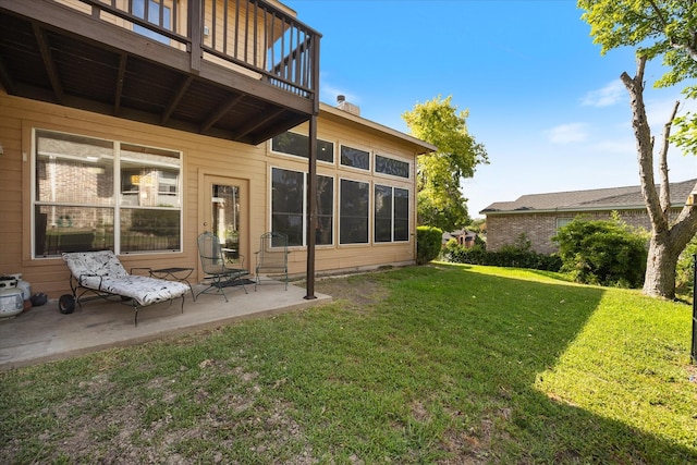 rear view of house with a patio and a yard