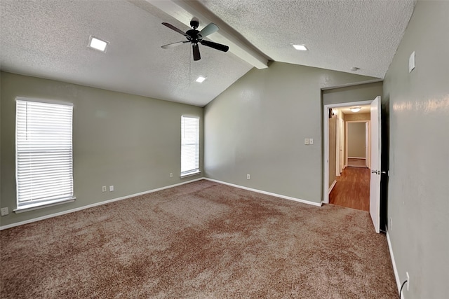 spare room with ceiling fan, a textured ceiling, carpet floors, and lofted ceiling with beams