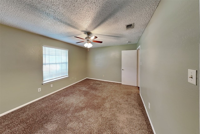 unfurnished room featuring ceiling fan, a textured ceiling, and carpet