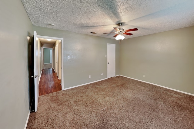 carpeted empty room featuring a textured ceiling and ceiling fan