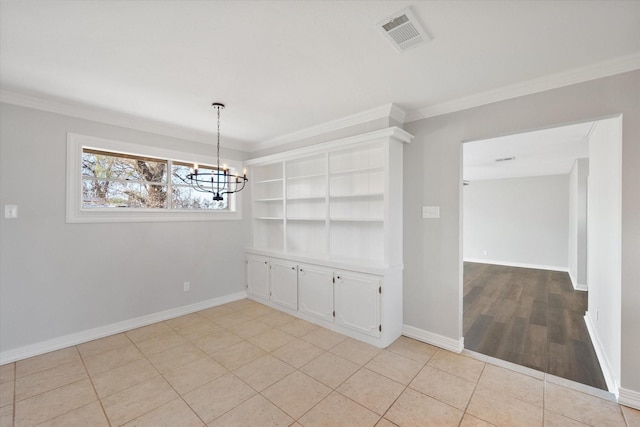 unfurnished dining area featuring light tile patterned floors, ornamental molding, and an inviting chandelier