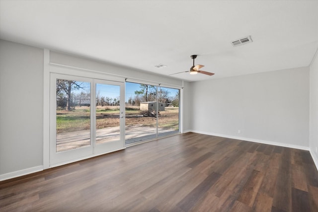 empty room featuring ceiling fan and dark wood-type flooring