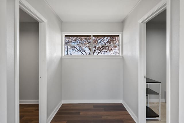 corridor featuring dark hardwood / wood-style floors and ornamental molding