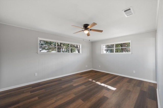 unfurnished room featuring ceiling fan, crown molding, and dark wood-type flooring