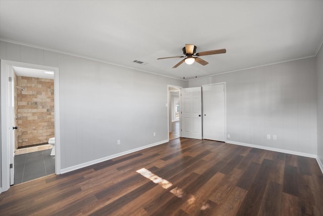 unfurnished bedroom featuring ceiling fan, dark hardwood / wood-style floors, ensuite bathroom, and ornamental molding