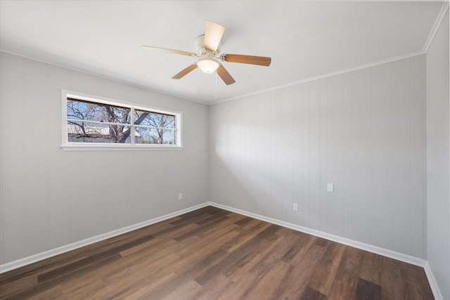 unfurnished room with ceiling fan, dark hardwood / wood-style flooring, and ornamental molding