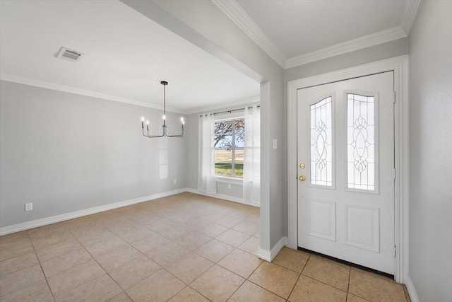 tiled foyer with crown molding and a chandelier