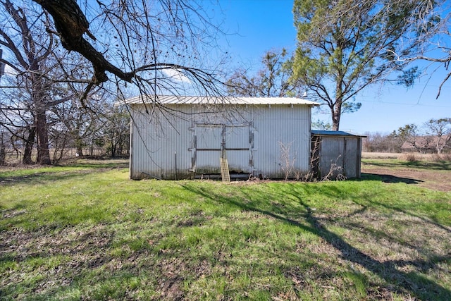 view of outbuilding featuring a lawn