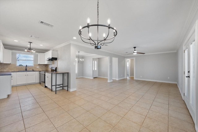 kitchen with white cabinets, ornamental molding, stainless steel range with electric stovetop, and tasteful backsplash