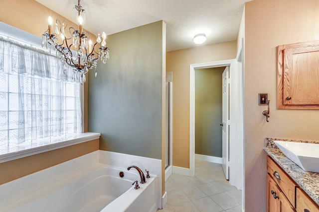 bathroom featuring a textured ceiling, tile patterned floors, vanity, a chandelier, and independent shower and bath