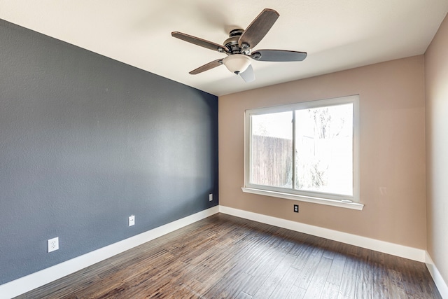 spare room with ceiling fan and dark hardwood / wood-style floors