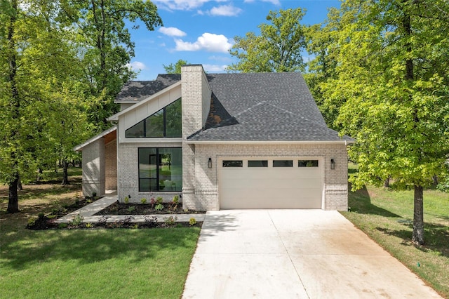 view of front of property with a garage and a front lawn