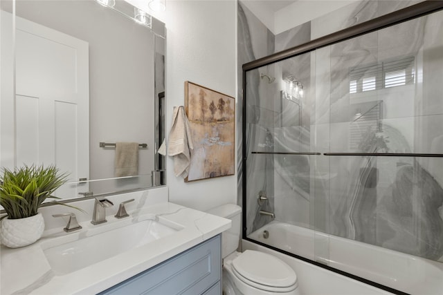 full bathroom with vanity, toilet, and combined bath / shower with glass door