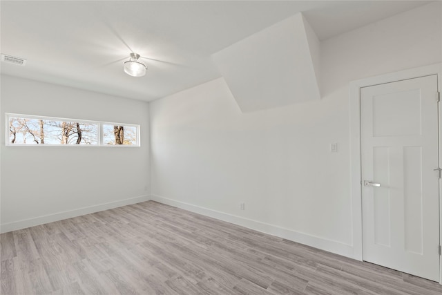 empty room with light hardwood / wood-style floors