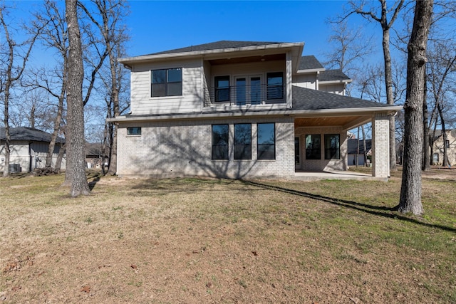 back of property featuring a yard and a patio