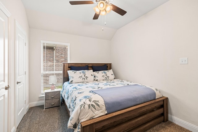 bedroom with ceiling fan, lofted ceiling, and dark colored carpet