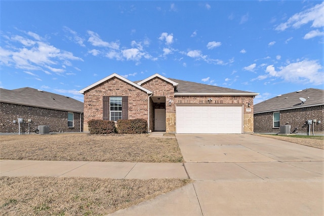 view of front of property featuring central AC and a garage