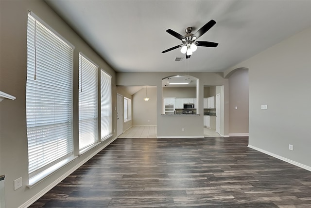 unfurnished living room featuring ceiling fan and wood-type flooring