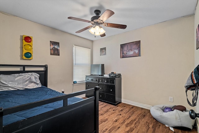 bedroom featuring wood-type flooring and ceiling fan