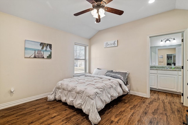 bedroom featuring lofted ceiling, dark hardwood / wood-style floors, sink, and ceiling fan