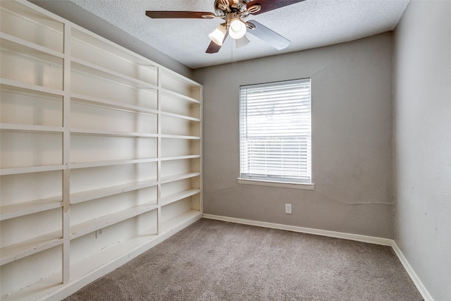 carpeted spare room with ceiling fan and a textured ceiling