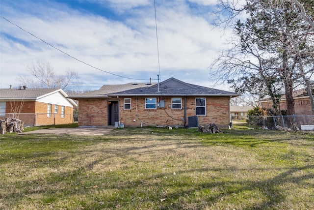 back of property featuring cooling unit, a patio, and a lawn