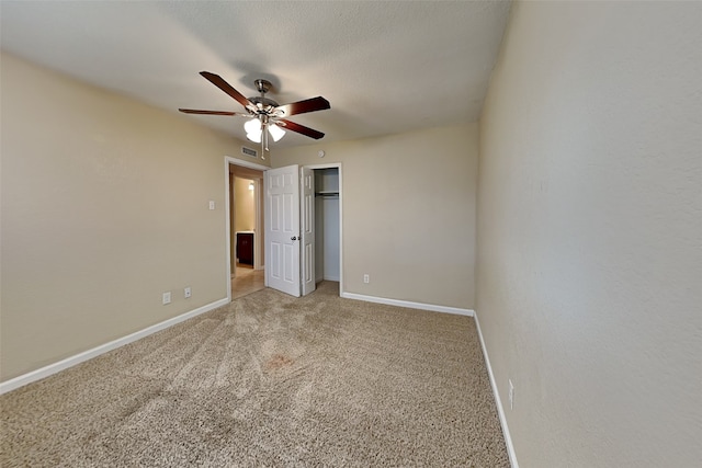 unfurnished bedroom featuring light colored carpet and ceiling fan