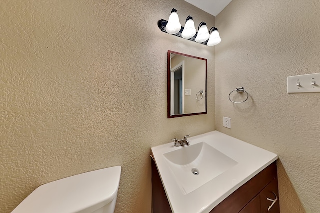 bathroom featuring toilet and vanity