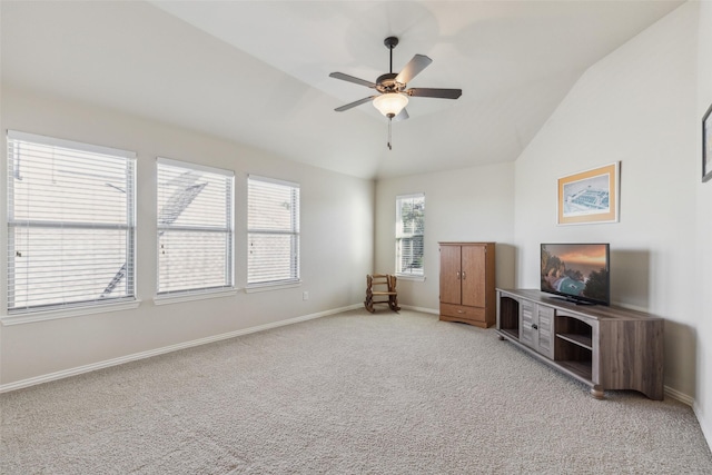 unfurnished living room with vaulted ceiling, light colored carpet, and ceiling fan