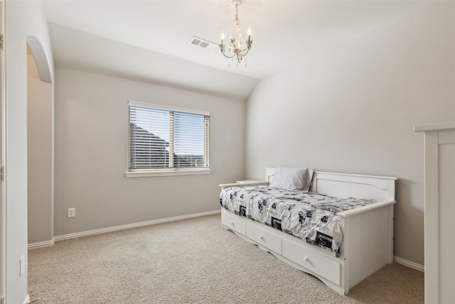 bedroom with lofted ceiling, light colored carpet, and an inviting chandelier