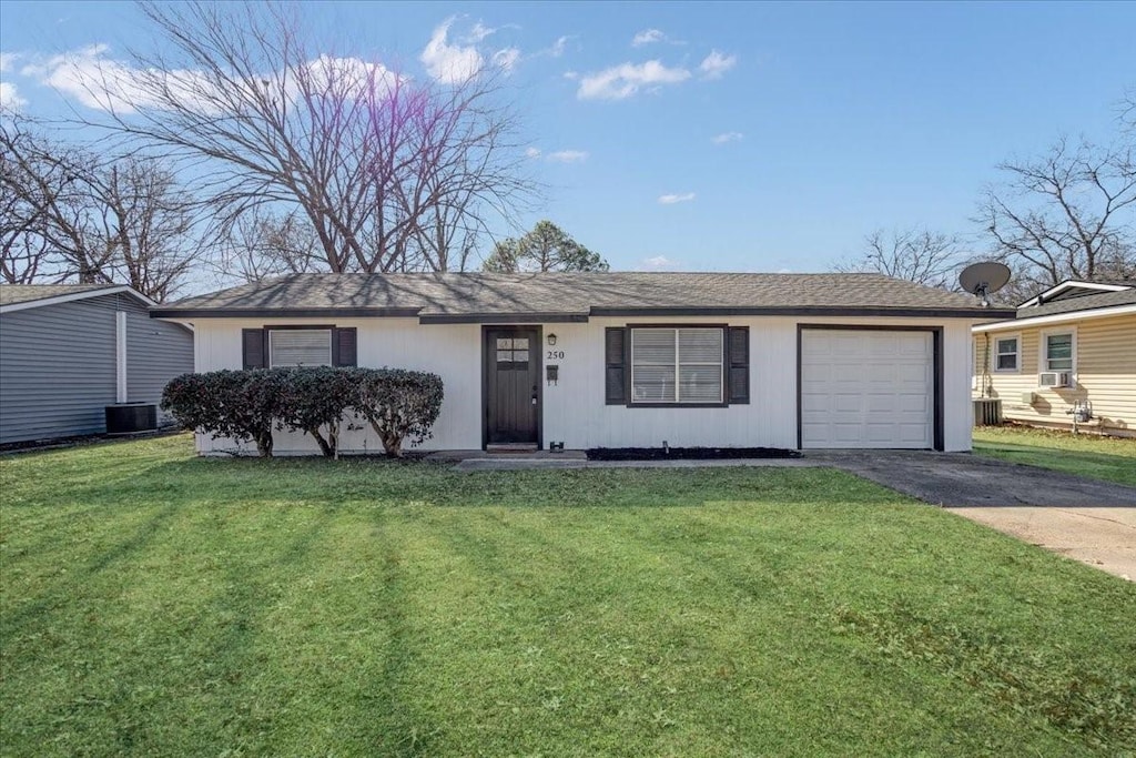 ranch-style home with central AC, a garage, and a front yard