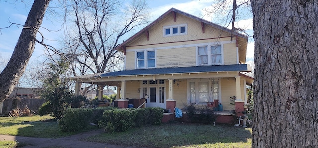 view of front of house with covered porch and a front yard