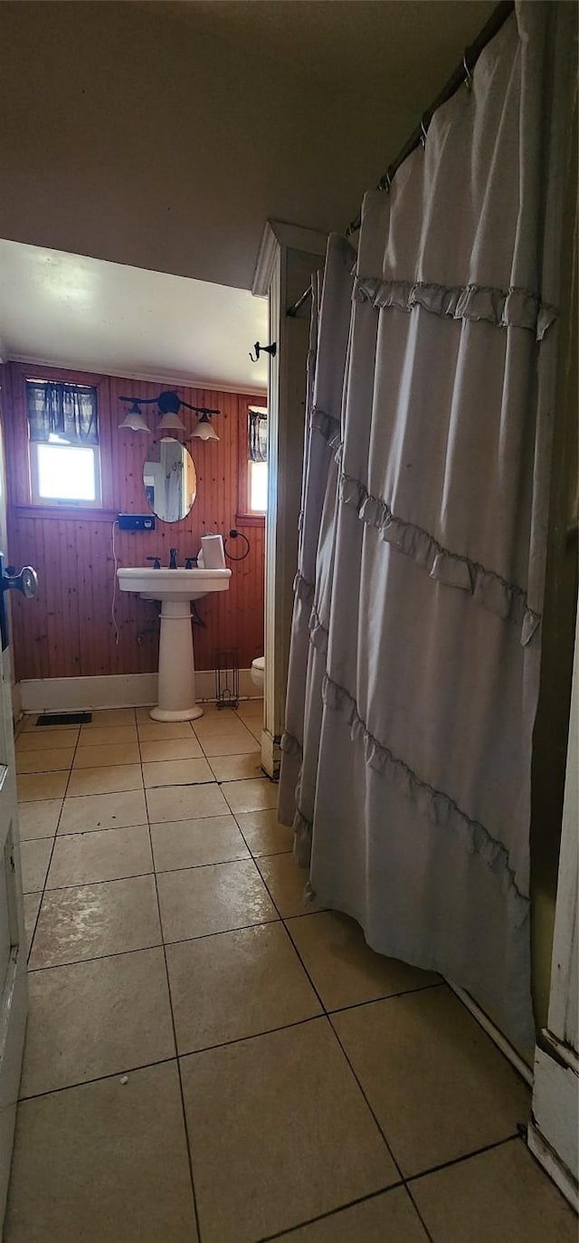 bathroom featuring sink, toilet, and tile patterned flooring