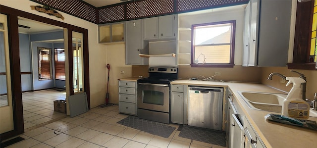 kitchen with sink, appliances with stainless steel finishes, and light tile patterned flooring