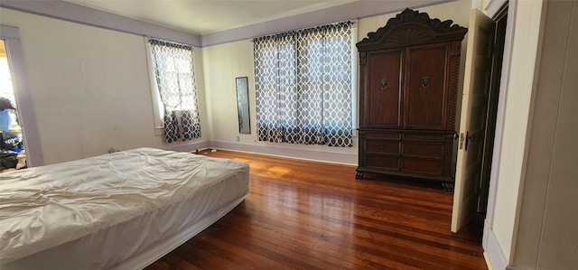 bedroom featuring dark hardwood / wood-style flooring