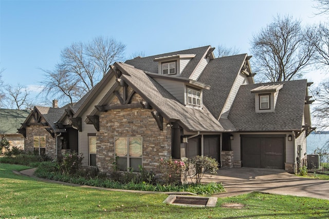 view of front facade with central air condition unit, a garage, and a front lawn